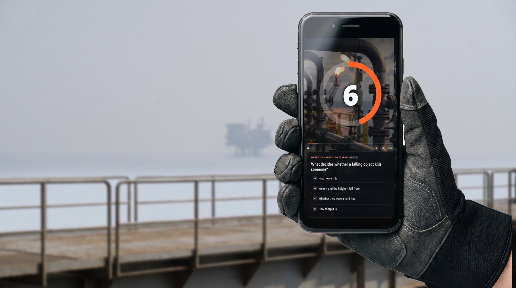 A ResponseShield drill running on a phone held in a gloved hand on an offshore walkway: a countdown ring over paused video, and the question 'What decides whether a falling object kills someone?' with four answers.
